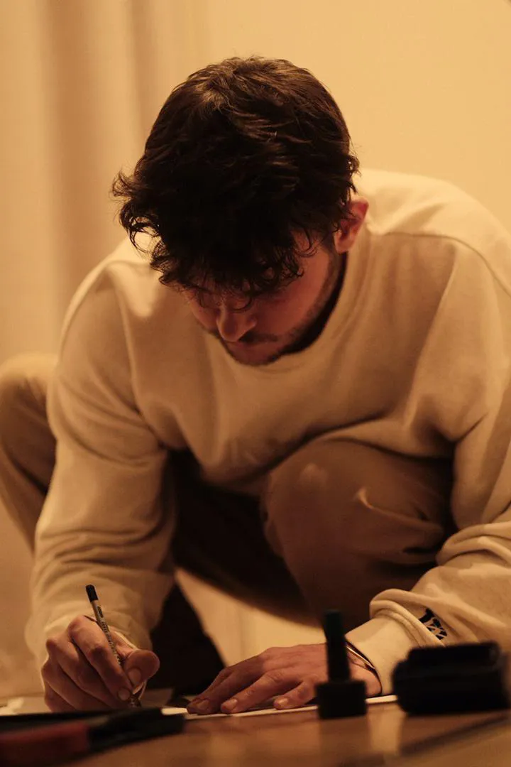 A shoemaker taking foot measurements for a pair of custom shoes